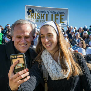 President Rev. John I. Jenkins, C.S.C. poses for a student's selfie at the March for Life in Washington D.C.