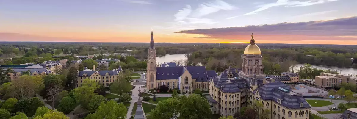 Aerial view of main building and basilica during sunset.